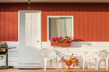 Typical small clean motel room with deck furniture, Atlantic coast island, Canada
