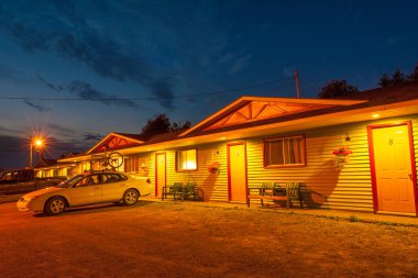 Typical small clean motel with parked cars in Nova Scotia at night, Canada
