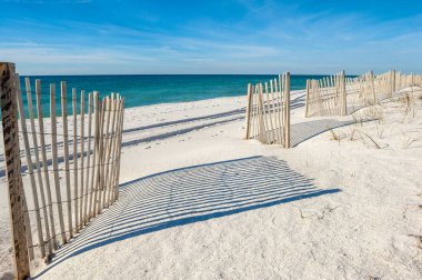 White sandy beach with fences,  Gulf of Mexico coast, Alabama Gulf shores, USA