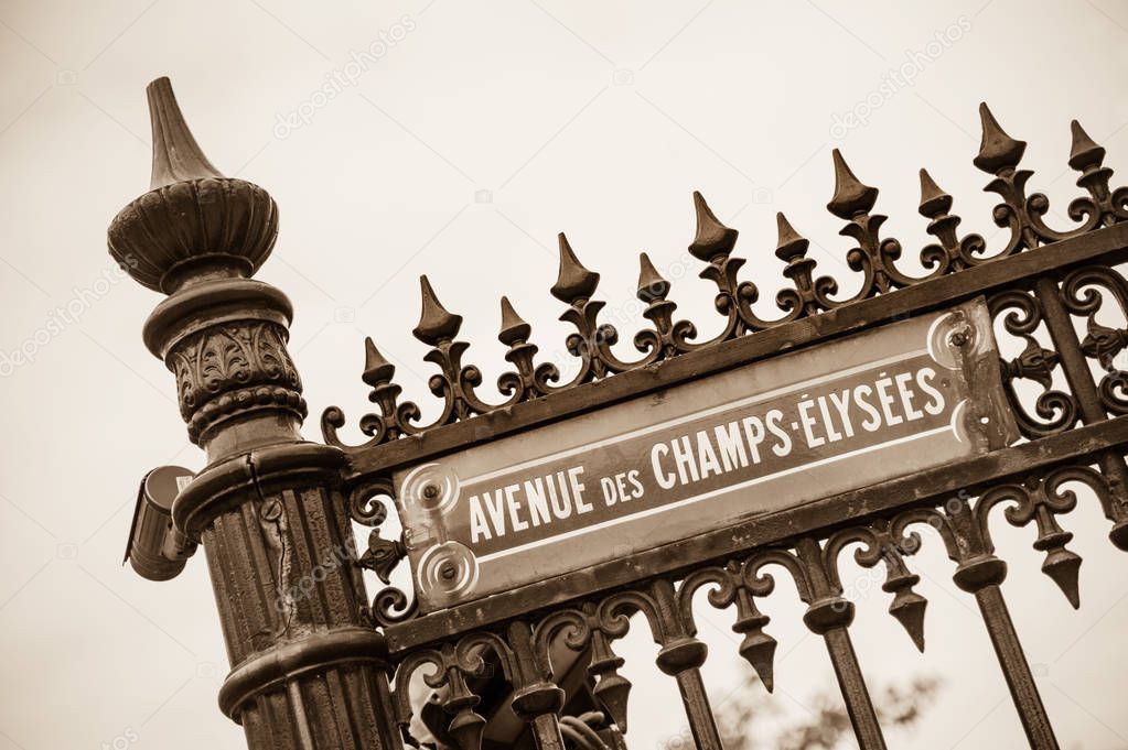 Avenue des Champs-Elysees street sign on typical wrought iron metal fence, Paris, France