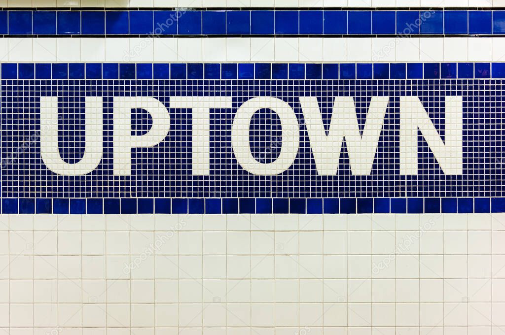 New York city subway sign towards uptown in midtown Manhattan station, USA