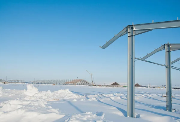 The frame of the building of metal. Prefab building site. The use of a metal frame. Construction for further use on the farm.