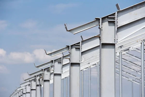 Part of the building structure of galvanized parts. Galvanized parts on a construction site in rainy weather. Waiting for the installation of metal structures. Galvanized metal is not exposed to corrosion.