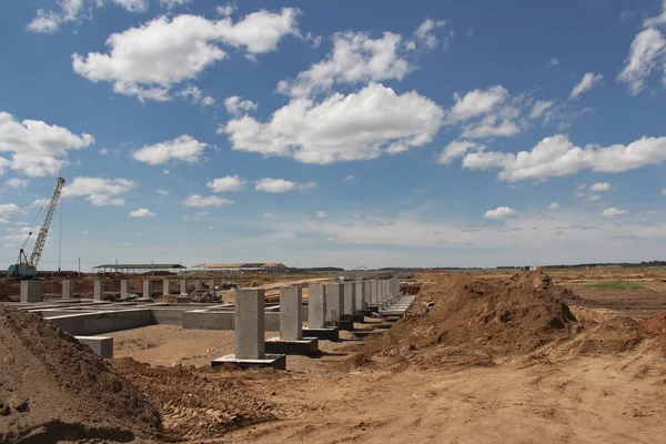 The organization of concrete work. Pouring concrete at a construction site. Construction of a new building. Filling of the basis and columns of a new building.