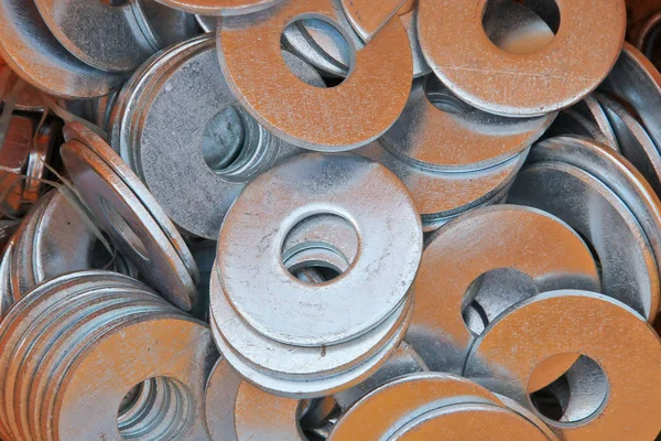 Galvanized metal mounting nuts. Hardware for fastening metal. Equipment for the installation of building structures