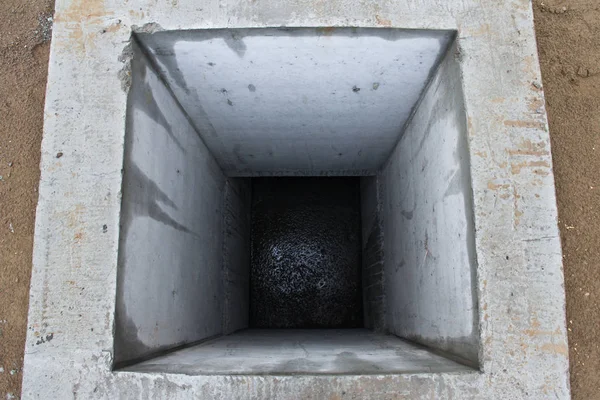 Sewer well of concrete square shape. City infrastructure.