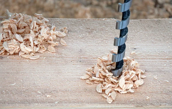 Woodwork. Drilling wooden beams. Wood construction. Construction of a new building.