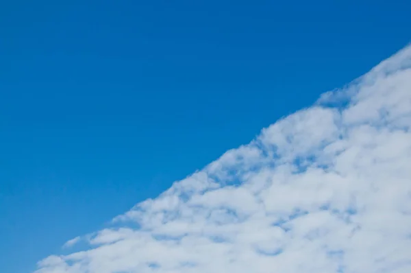 Spring blue sky with clouds. White clouds come on the blue sky.