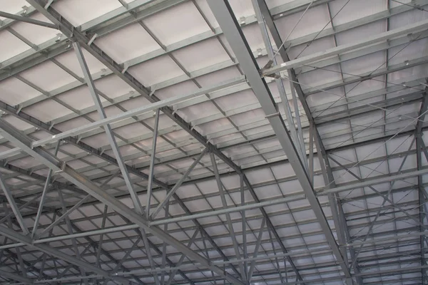 Thermal insulation of the metal frame of the building with insulation panels. The process of installing insulation panels. Modern building insulation.