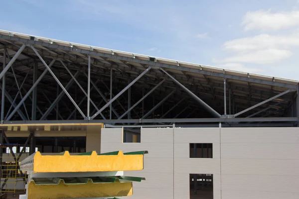 Thermal insulation of the metal frame of the building with insulation panels. The process of installing insulation panels. Modern building insulation.