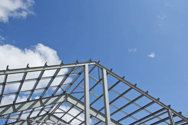 The structure of the steel frame for building construction on sky background. Zinc metal coating to protect against corrosion.