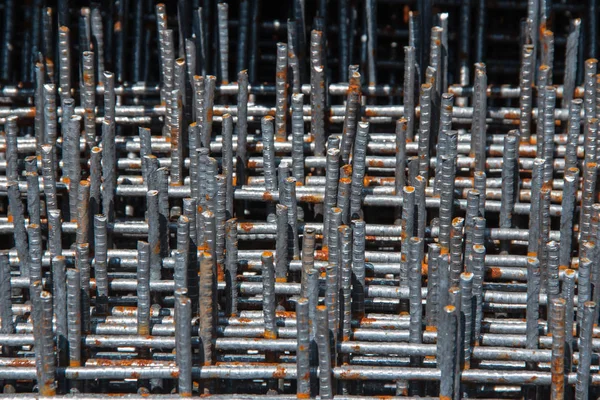 Billets of metal rods for concreting the columns of the building. Metal base of reinforced concrete walls. Part of the structure of the building of reinforced concrete.