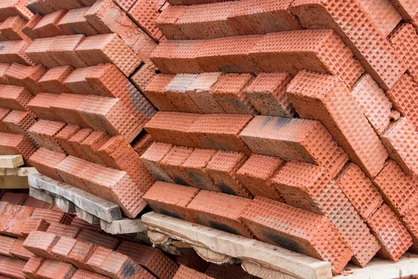 New red clay bricks for masonry building walls. Material for the construction of a new building.