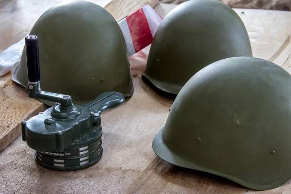 Russian military helmet on a wooden background. The classic form of a helmet to protect the head from splinters.