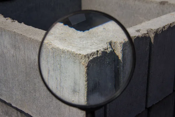 Industrial background through a magnifying glass. Brick texture. Brick blocks used during the construction of a new building.