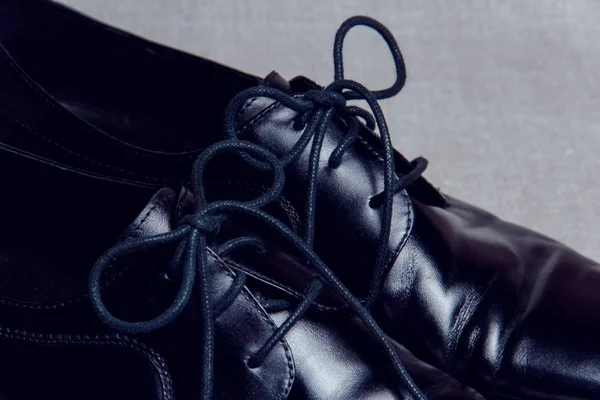 Tied shoelaces on men\'s shoes. Classic men\'s shoes in black.