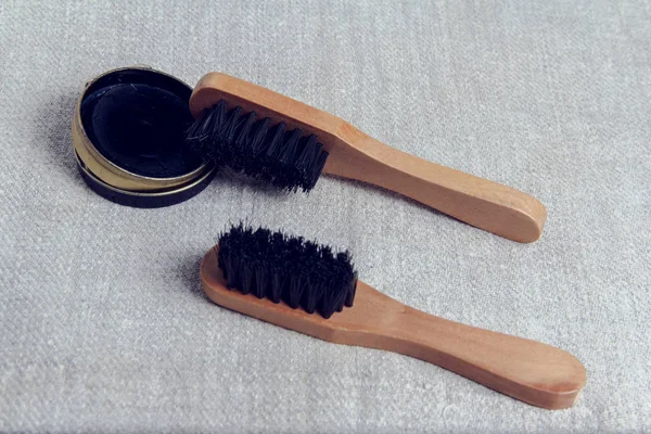 Shoe Care Kit: Brushes and paste for cleaning shoes.