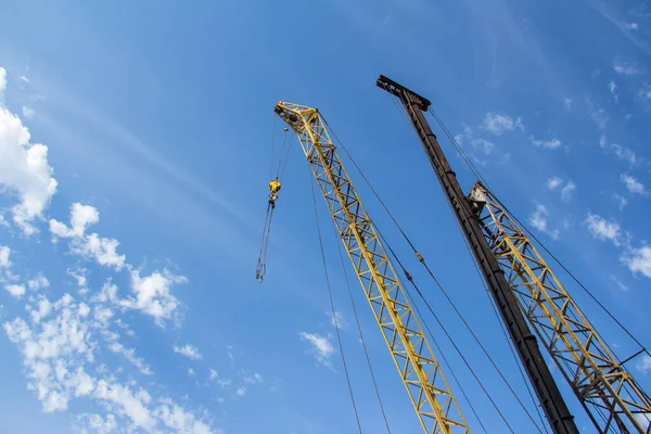Tower crane and Bore pile rig machine at the construction site in Construction machinery against a blue sky with clouds