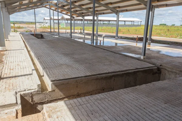 Concrete floor with building under construction. Concrete base of the floor. Construction of the hangar