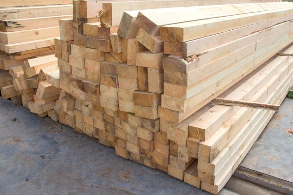 Large wooden beams for construction. Building material. Sawed beam