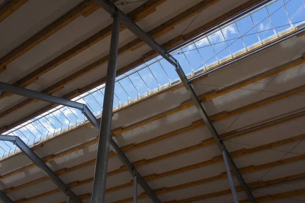 Metal frame of the building with a sandwich panel of insulation on the wall. Construction of a new industrial building. Modern Insulation of the walls of the building panels of insulation.