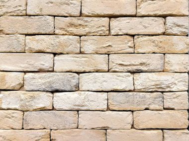 Açık renkli tuğlalar. Duvarın bir parçası. Soyut dokusal arka plan. Ön görünüm.