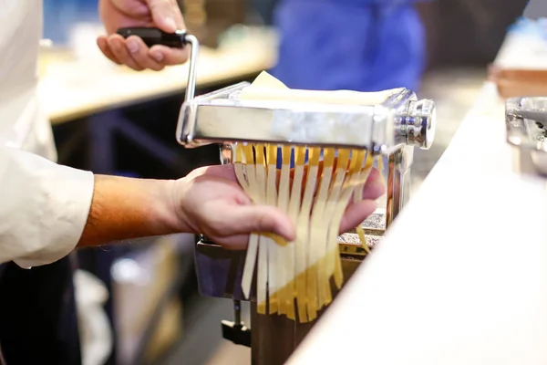 Chef making pasta with a machine, home made  fresh pasta