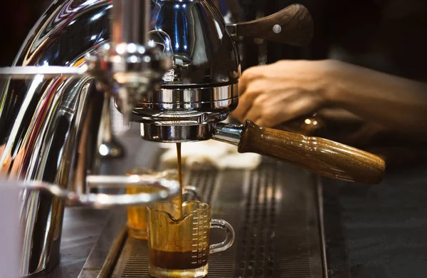 Espresso shot from coffee machine in coffee shop,Coffee maker in coffee shop