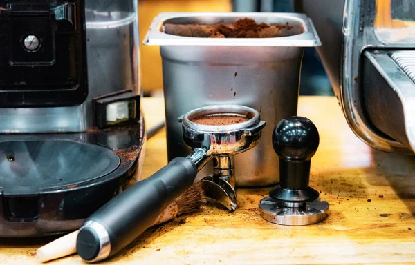 Barista working in a coffee shop, Close up of barista presses ground coffee using tamper, Barista Make Coffee Portafilter Concept