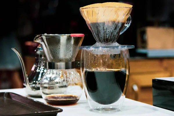 Drip coffee brewing, Barista pouring water on coffee ground with filter