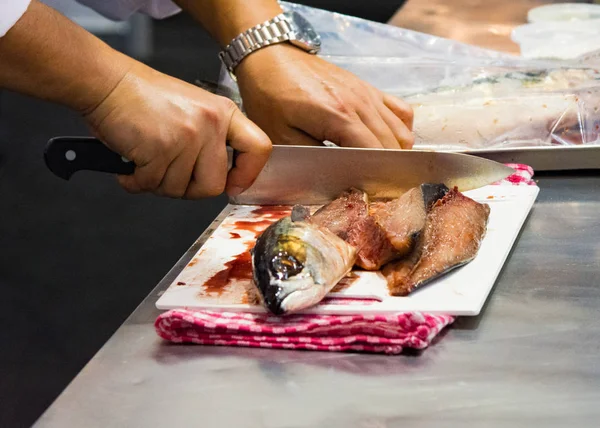 Chef cutting fish, Chef slices fish fresh on Board in the kitchen