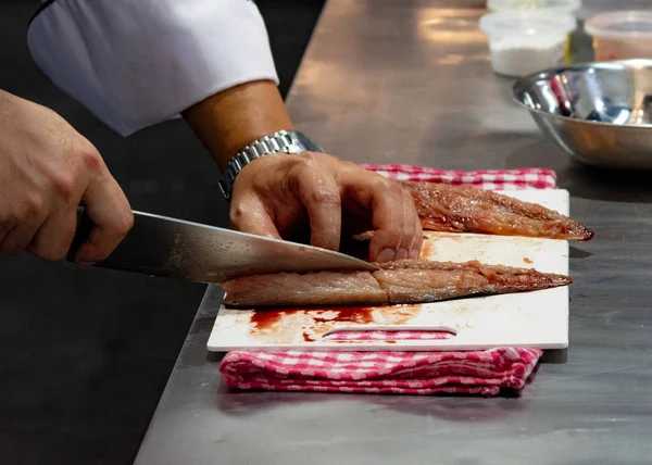 Chef cutting fish, Chef slices fish fresh on Board in the kitchen