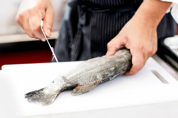 chef at work, chef filleting fish at the kitchen, Chef in restau