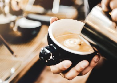 Espresso makinesi kahve demliyor. Kahve bardak içine dökülen i