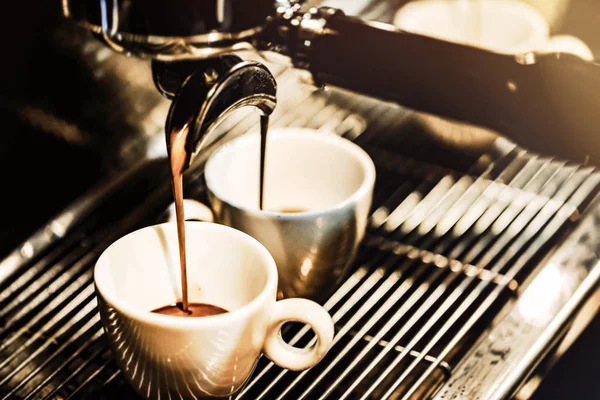 Espresso makinesi kahve demliyor. Kahve bardak içine dökülen i