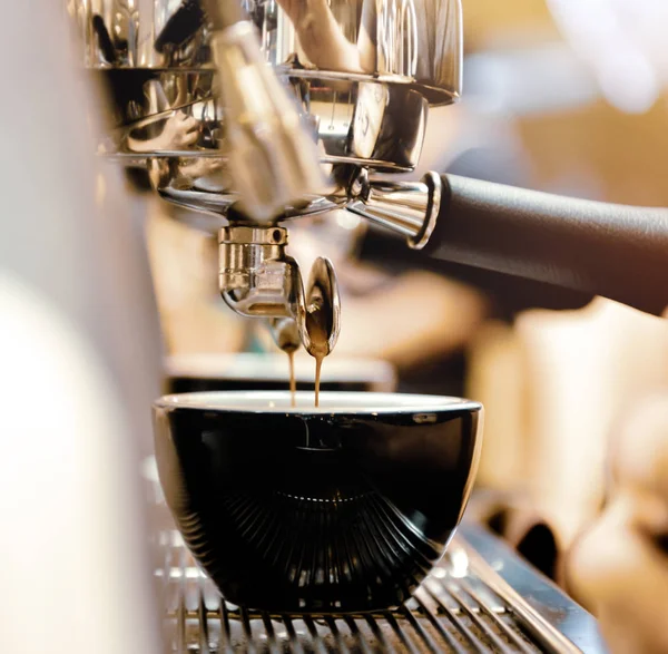 Espresso machine brewing a coffee. Coffee pouring into glasses i