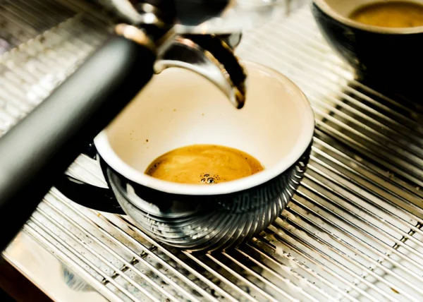 Espresso machine brewing a coffee. Coffee pouring into glasses i