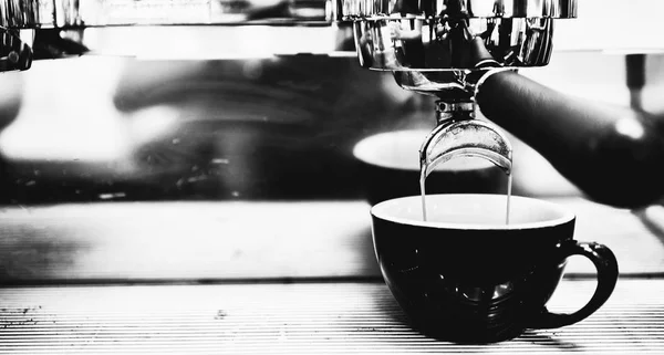 Espresso machine brewing a coffee. Coffee pouring into glasses i