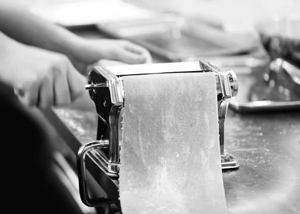 Chef making pasta with a machine, home made  fresh pasta