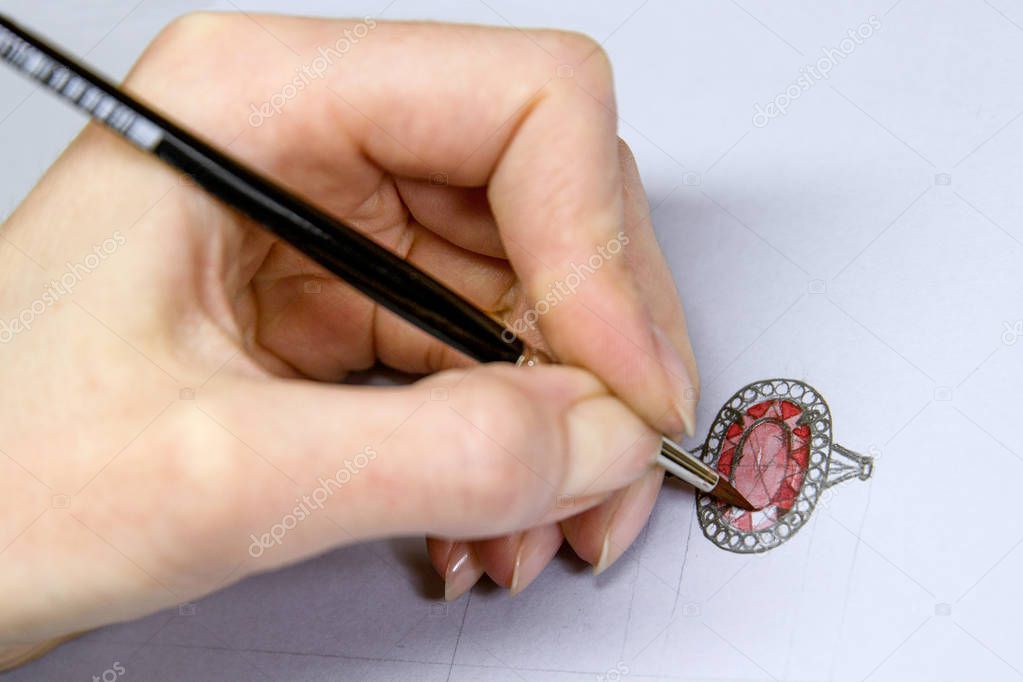 Drawing Jewelry Design. Artist designer drawing sketch jewelry on paper . Hand made.