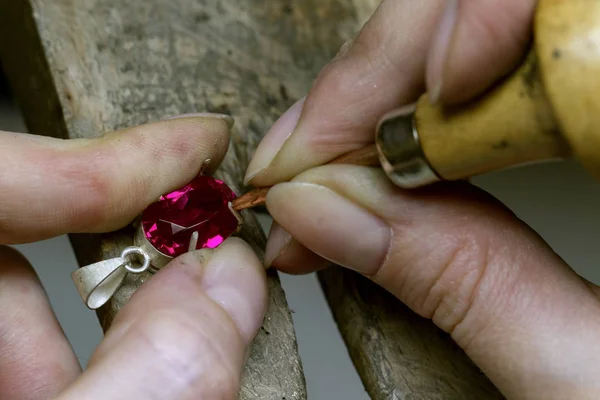 Profession jeweler. Craft jewelry making with professional tools. A handmade jeweler process. Close up.