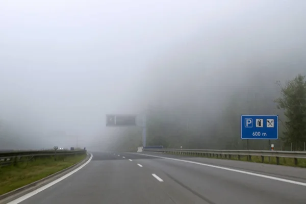 Traffic safety in heavy fog. Fall travel, bad weather.