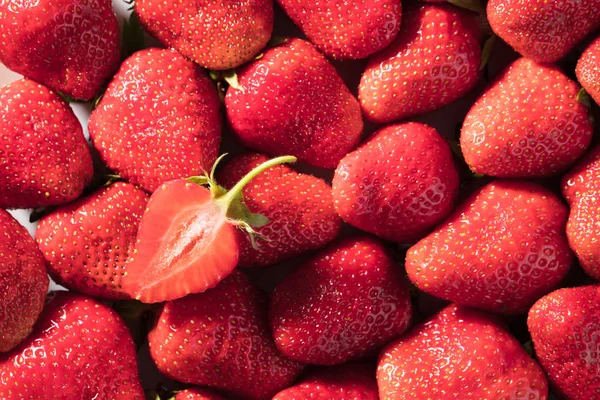 Berry background from a fresh strawberry texture closeup