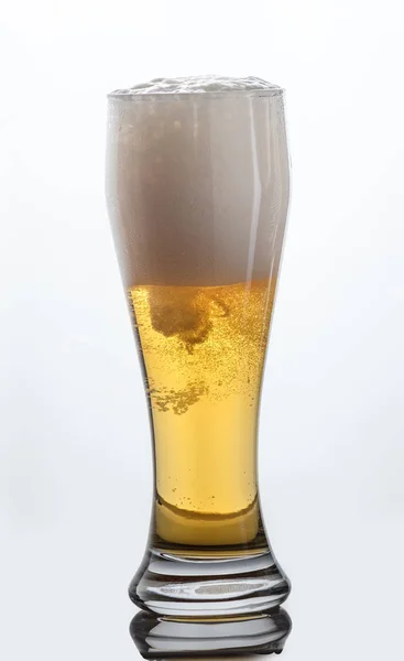 Glass of light beer on white background