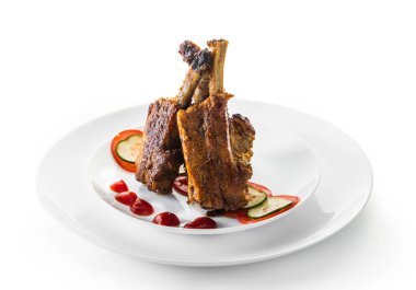 beyaz bir arka plan üzerinde sos ve sebze ile kızarmış kaburga