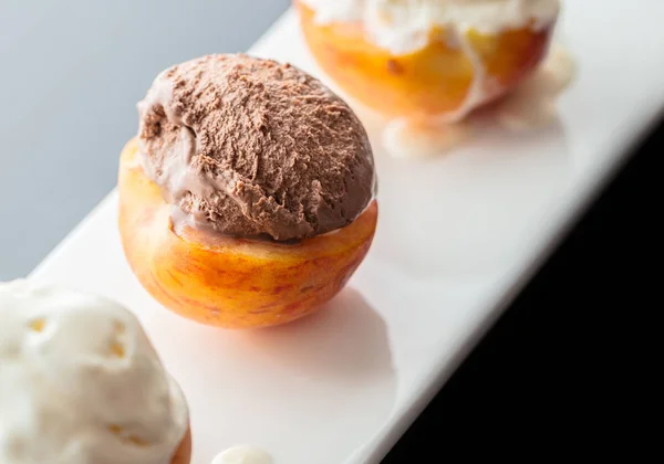 Dessert peach with ice cream ball close-up