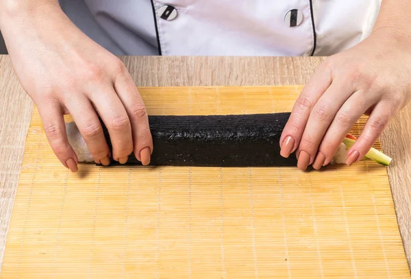 Japanese chef. Chef prepares rolls, hands closeup