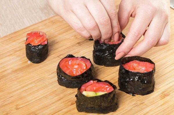 Japanese chef. Chef prepares rolls, hands closeup