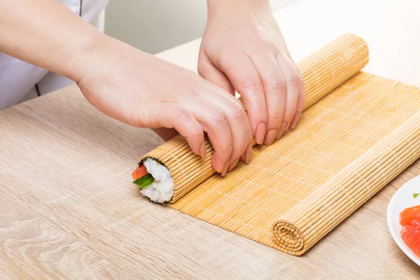 Japanese chef. Chef prepares rolls, hands closeup