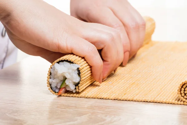 Japanese chef. Chef prepares rolls, hands closeup